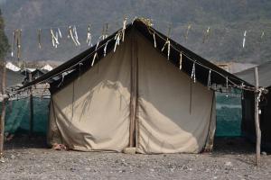 a tent sitting on the beach with clothes lines at Wild Leaf Camps in Rishīkesh
