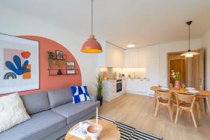 a living room with a couch and a table at Design apartment • Balcony • Free Parking • Yoga • 10 mins to center in Prague