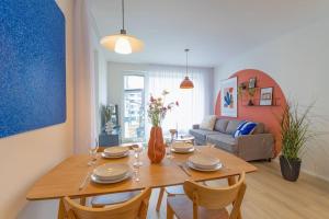 a living room with a wooden table with chairs at Design apartment • Balcony • Free Parking • Yoga • 10 mins to center in Prague