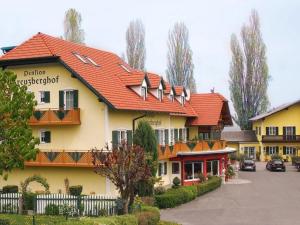 a large building with a red roof at Pension Kreuzberghof in Großklein