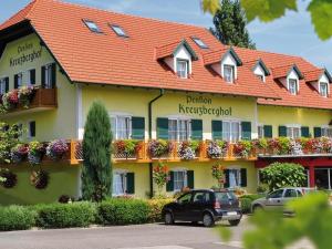 a hotel with a car parked in front of it at Pension Kreuzberghof in Großklein