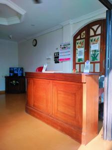 a wooden bar in a room with a counter at Calangute Beach Front in Calangute