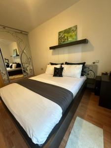 um quarto com uma cama grande e lençóis brancos em Apartman Azra em Usje