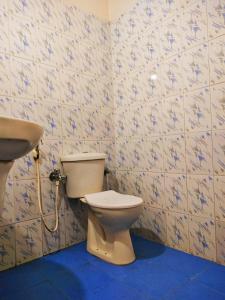a bathroom with a toilet and a sink at Calangute Beach Front in Calangute