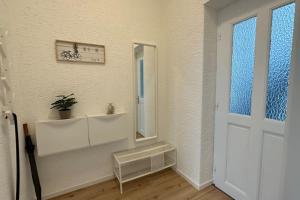 a white room with a mirror and a door at Limburgs Herzstück in Limburg an der Lahn