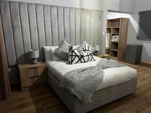 a bedroom with a bed with a large headboard at Mulala Luxury Guesthouse in Thohoyandou +23 photos