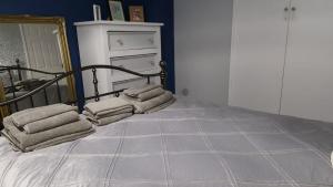 a bedroom with a bed with towels on it at Waterfall's in Borrowash