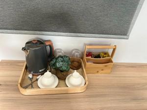 a tray with a tea pot and cups on a table at Mulala Luxury Guesthouse in Thohoyandou