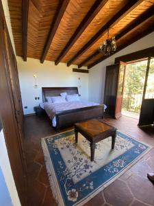a bedroom with a bed and a coffee table at Villa del Lago in Pátzcuaro