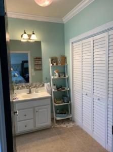 a bathroom with a sink and a mirror at At Ease in Ocean Springs