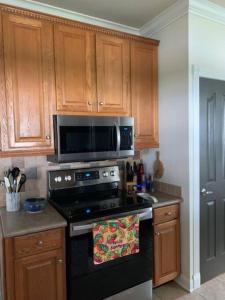 a kitchen with a black stove and a microwave at At Ease in Ocean Springs