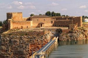 a building with a bridge over a body of water at AniCa II, el lugar de la Mancha in Argamasilla de Alba
