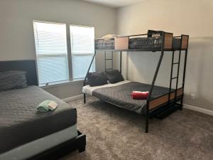 a bedroom with two bunk beds and a bed at The Jewel of Jacksonville in Jacksonville