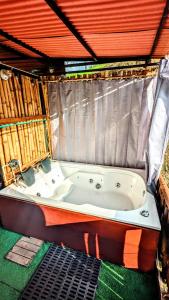 a bath tub sitting inside of a tent at Glamping Reserva del Roble in La Vega
