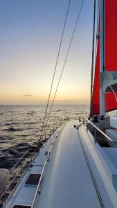 a sailboat in the ocean at sunset at "Marea" Sunreef 62 Catamaran with Crew all inclusive in Isla Wichitupo Grande