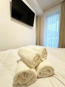 Una pila de toallas encima de una cama en Błękitny Brzeg - przy samej plaży, en Międzyzdroje