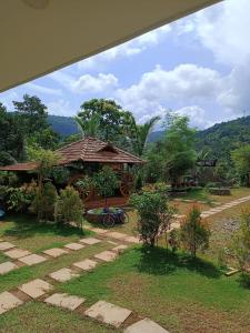 a resort with a building with a mountain in the background at Wild Mist Homestay in Rānī