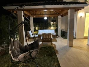 a porch with a swing and a living room at Sunshine Villa in Fethiye
