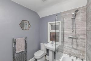 a bathroom with a shower and a toilet and a sink at Town Centre Town House free WiFi and free on street parking in Middlesbrough