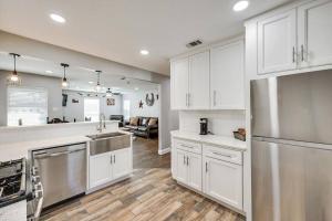 a kitchen with white cabinets and stainless steel appliances at The Texas Experience near the Stockyards! in Fort Worth
