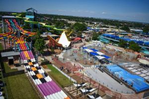 an aerial view of an amusement park with a carnival at The Texas Experience near the Stockyards! in Fort Worth