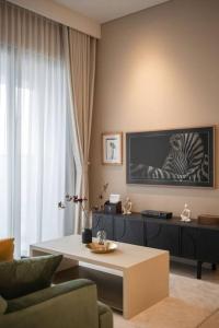 a living room with a couch and a table at The Rixx Trendy Apartmen 2bed 1bath at The Marq in Ho Chi Minh City