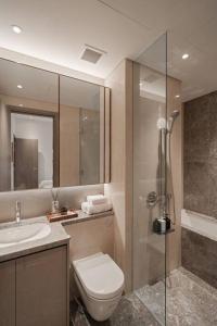 a bathroom with a toilet and a sink and a shower at The Rixx Trendy Apartmen 2bed 1bath at The Marq in Ho Chi Minh City