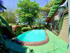 a swimming pool in a backyard with a water fountain at Casa Pochotal in Cartagena