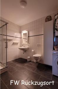 a bathroom with a toilet and a sink at Ferienwohnungen im Alten Bahnhof in Osnabrück