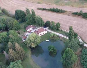 an aerial view of a house and a lake at Maison au bord de rivière in Gissey-sur-Ouche