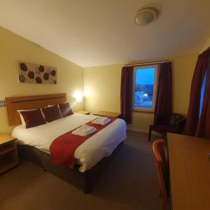 a hotel room with a bed and a window at The Brae Hotel in Brae