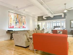 a living room with furniture and a painting on the wall at The Historic Lyric Penthouse with Private Rooftop in Cincinnati