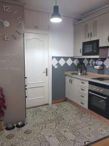 a kitchen with white cabinets and a white door at Apartamento Barrionuevo in Córdoba