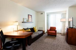 a living room with a couch and a table at Residence Inn Florence in Florence +37 photos