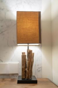 a lamp sitting on a table with drift wood at Gangnam Boutique Hotel Sohsul in Seoul