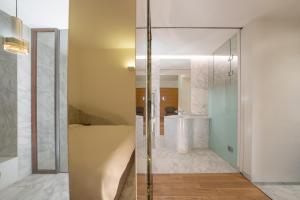 a bathroom with a glass shower with a sink at Gangnam Boutique Hotel Sohsul in Seoul