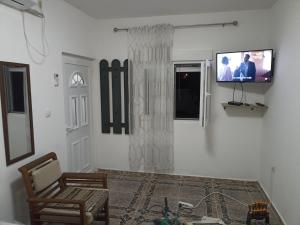 a living room with a tv on a wall at Mini Garsonjera in Podgorica