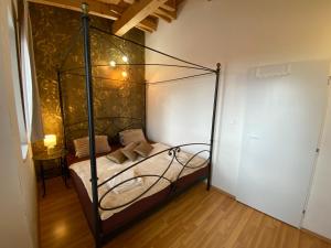 a bedroom with a bed with a metal canopy at Dream apartment in Bratislava