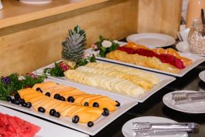 a buffet with three trays of food on a table at Hotel Miramar in Lima