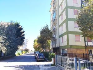 a building with a car parked on the side of a street at Appartamenti Cangini in Cesenatico