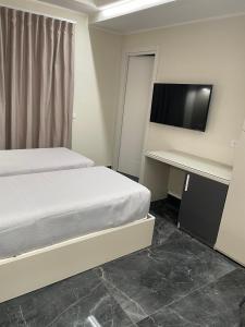 卡斯楚維拉里的住宿－B&B Cristallo，一间卧室配有一张床和一张书桌及电视