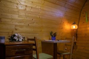 a table and chairs in a room with wooden walls at STD SRCE KAMENE GORE in Kamena Gora