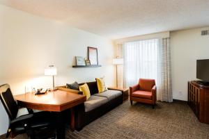 a living room with a couch and a table at Residence Inn Florence in Florence