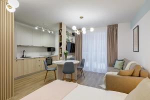 a living room with a couch and a table at Cozy Garden Studio - Free Parking - Wellness SPA in Sinaia