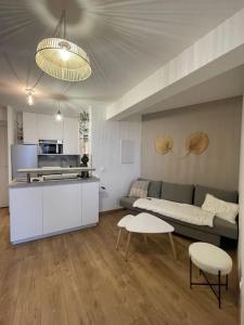 Il comprend un salon avec un canapé et une cuisine. dans l'établissement Bel appartement vue mer accès direct plage, à Canet