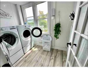 a laundry room with a washing machine and a window at 7-A Diamond in Yonkers in Yonkers