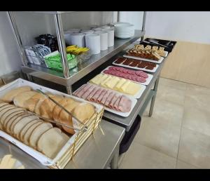 a table with different types of bread and pastries at Hotel Santa Emilia Salamanca in Salamanca