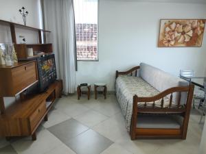 a living room with a bed and a television at Sobrado do Méier in Rio de Janeiro