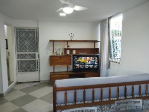 a living room with a couch and a television at Sobrado do Méier in Rio de Janeiro
