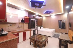 a kitchen with a couch and a table in a room at BK home stay in Transport Nagar